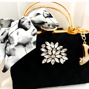 Black handbag with scarf and shoe charm.