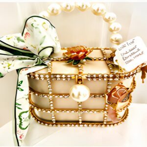 Ornate handbag with pearl accents and ribbon.