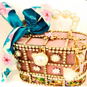 Decorative handbag with floral scarf and embellishments.
